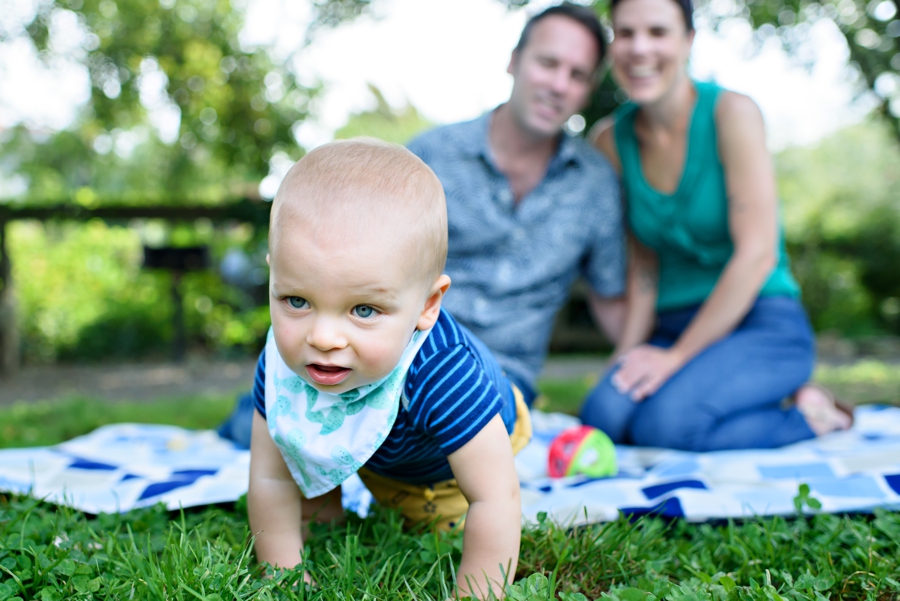 A baby crawls away from mom and dad at the park in Northern Liberties Philadelphia.